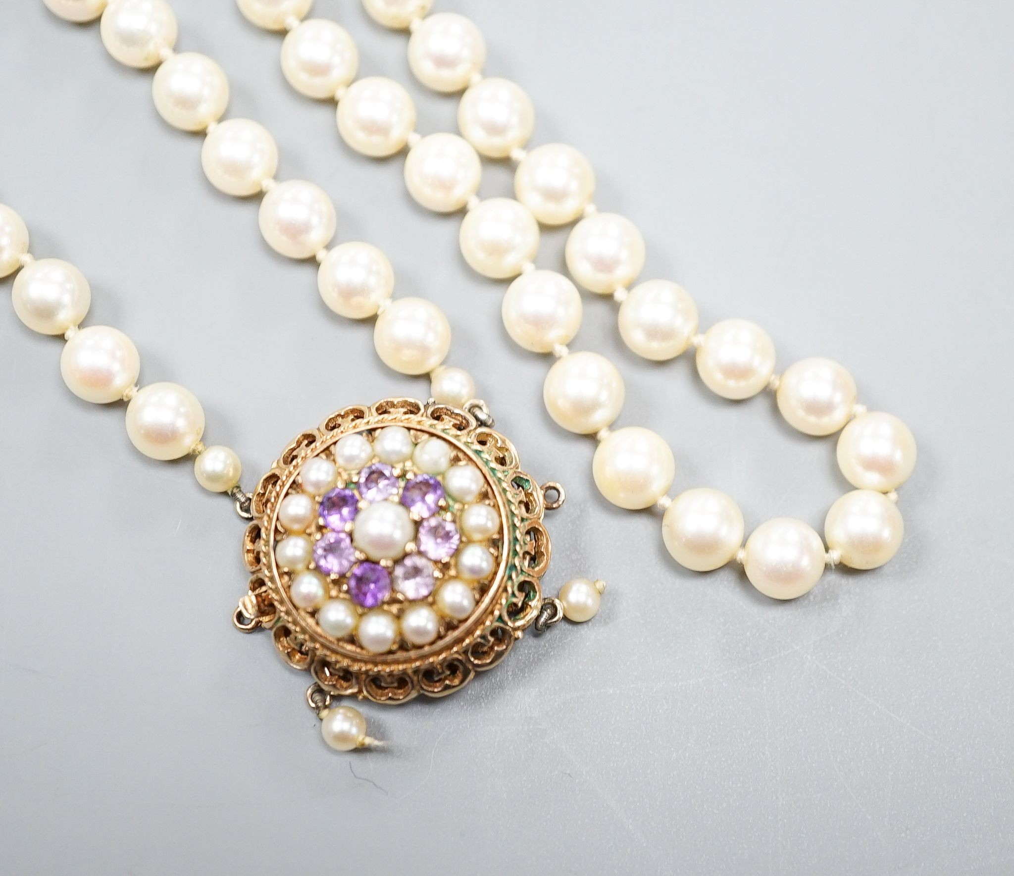 A 1960's double strand cultured pearl necklace, with 9ct gold, amethyst and cultured pearl set clasp (a.f.), approx. 40cm